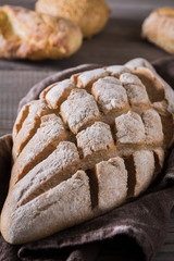 Freshly baked traditional bread on wooden table