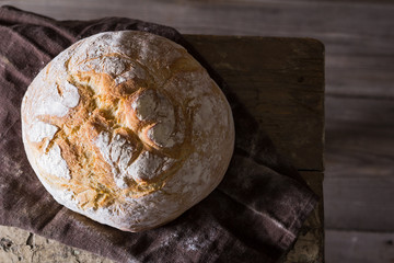 Freshly baked traditional bread on wooden table