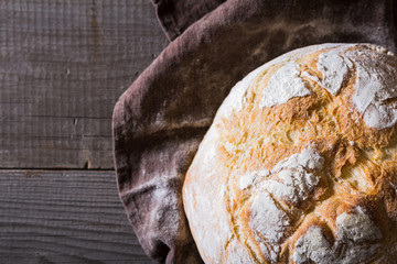 Freshly baked traditional bread on wooden table