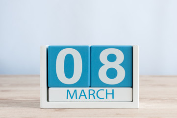 Happy International Women's Days. March 8th. Day 8 of month, daily calendar on wooden table background. Empty space for text.