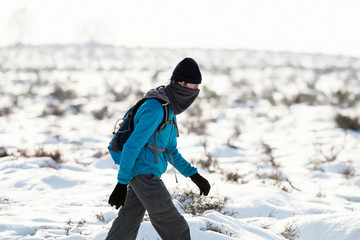 Fototapeta na wymiar Hiker outdoor in snowy winter landscape.