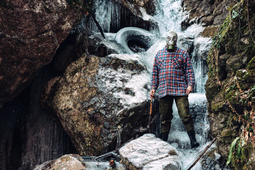 Scary man in the frozen waterfall