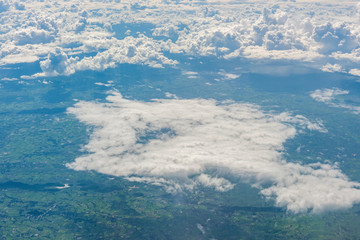 Aerial view of clouds and blue sky through airplane window, blue sky with cloud, many cloud in blue sky