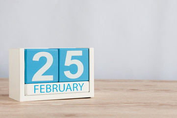 February 25th. Day 25 of month, calendar on wooden table background. Winter concept. Empty space for text