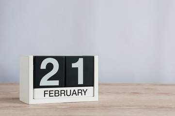 February 21st. Day 21 of month, black and white calendar on wooden desk background. Winter time. Empty space for text