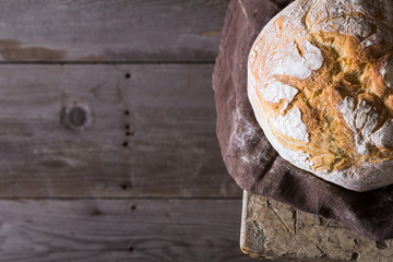 Freshly baked traditional bread on wooden table