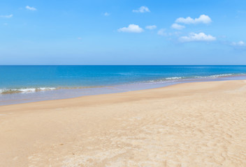 Fototapeta na wymiar white soft wave on empty tropical beach and blue sea 