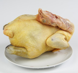Raw chicken on a white plate