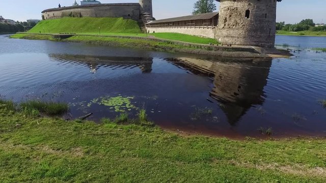 Ascending view on Ploskaya tower and Pskov Kremlin from side of river Pskova in Pskov, Russia
