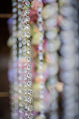 Crystal chains hang from steel wedding altar