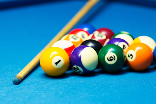 pool billiard balls and cue on the blue cloth table