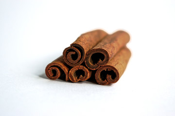Closeup of cinnamon sticks on a white background