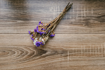 bouquet of wild flowers on a wooden background
