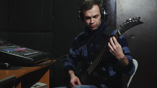 4k musician headphones play guitar in small studio and record session