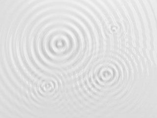 Fototapeta na wymiar Ripples on a white liquid surface.