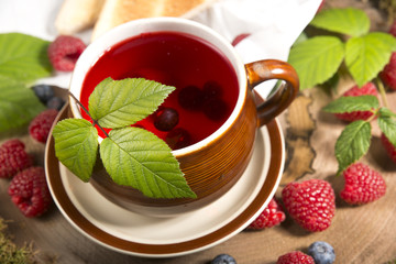 raspberry tea on a stump in the forest mushrooms and berries