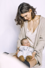 new born baby boy sleeping, crying on mother's arm. fashion mother.