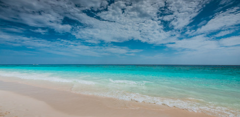 Sand beach turquoise sea cloud blue sky view background.
