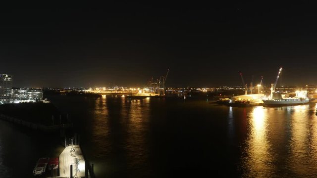 view from the elbphilharmonie in Hamburg with ships passing by and container ships being loaded and unloaded in Hamburg, Germany 2017