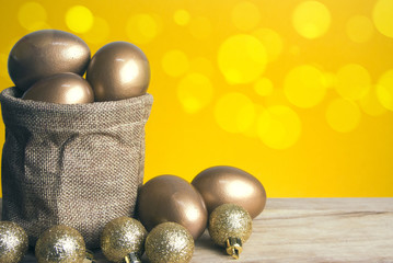 gold eggs in sack and yellow bokeh
