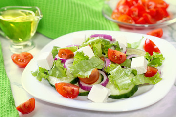 Fresh greek salad on white table