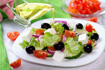 Fresh greek salad on white table