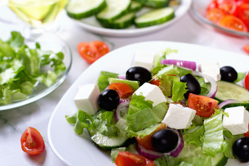Fresh greek salad on white table
