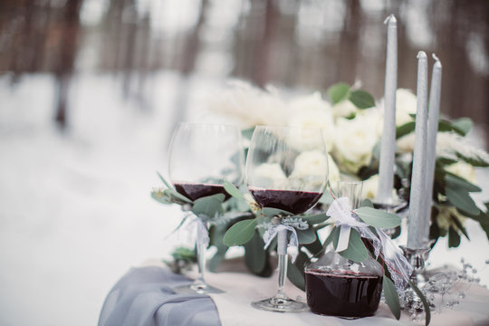 Beautiful stylish wedding glasses and bouquet on the table outside
