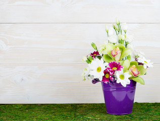 Flower arrangement on wooden background with space for your text