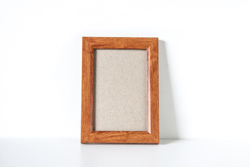 Blank wooden photo frame on the shelf