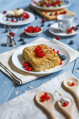 Pastry pie, tea, coffee and berries at blue rustic wood