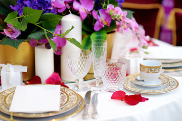 Beautiful table setting with crockery and flowers for a party, wedding reception or other festive event
