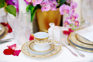 Beautiful table setting with crockery and flowers for a party, wedding reception or other festive event