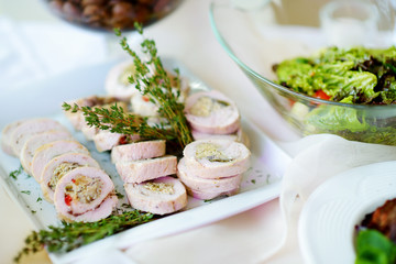 Delicious chicken or turkey rolls with herbs served on a party or wedding reception