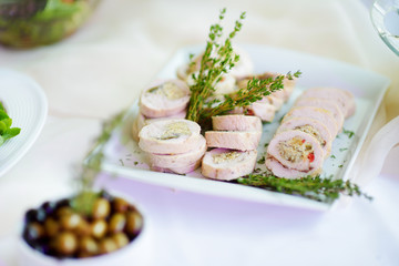Delicious chicken or turkey rolls with herbs served on a party or wedding reception