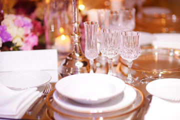 Beautiful table setting with crockery and flowers for a party, wedding reception or other festive event