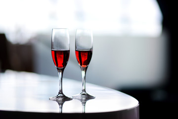 Two glasses of wine or another alcoholic beverage on a table