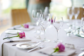 Beautiful table setting with crockery and flowers for a party, wedding reception or other festive event