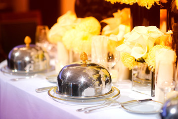 Beautiful table setting with crockery and flowers for a party, wedding reception or other festive event