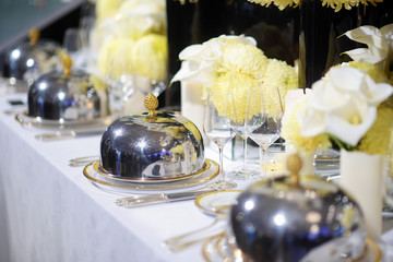 Beautiful table setting with crockery and flowers for a party, wedding reception or other festive event