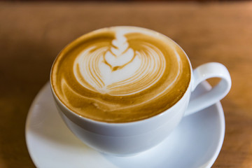 Art coffee .Cappuccino Coffee on Wooden table background