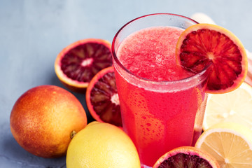 Glasses with blood orange and lemon lemonade Place for text Blue background