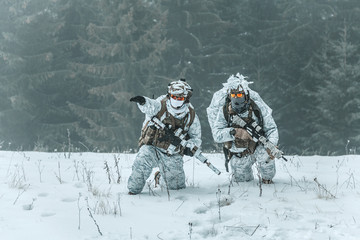 Winter arctic mountains warfare. Action in cold conditions. Pair of special forces weapons in...