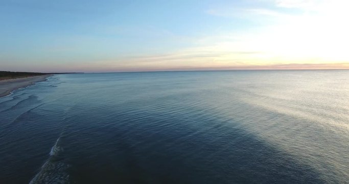 Aerial flight between the sea and the evening sky. Beautiful clear sunset of the Baltic sea - 1