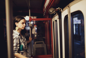 Fototapeta na wymiar interesting woman standing at the door of the train