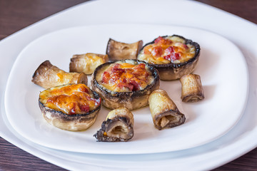 Baked mushroom caps stuffed with salami, prosciutto, garlic, butter and herbs