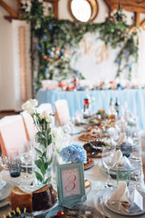 The frame with number and vase with flowers stand on the table