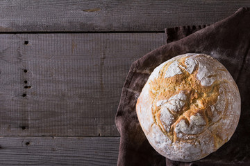 Freshly baked traditional bread on wooden table