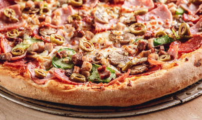 Italian pizza with cheese and olives macro. Pizza with mozzarella, olives and basil top view with copy space