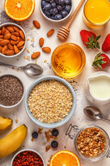 Ingredients for a healthy breakfast -  oatmeal, granola, honey, 